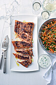 Sumac and olive oil roasted salmon with spiced carrot salad