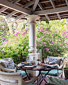 Terrasse mit Sitzgruppe und Blick in blühenden Garten