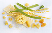 Different kinds of noodles on a white background