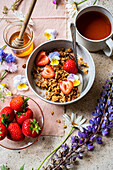 Almond Granola served with honey and strawberries and tea