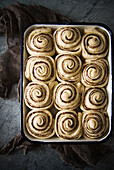 Unbaked cinnamon buns in a baking tin