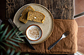 Slices of tasty fresh wholegrain loaf served on plate with cup of fresh milk