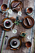 Table setting with ceramic crockery and chocolate desserts on a rustic tablecloth