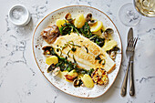 Lemon sole with clams, potatoes and green vegetables