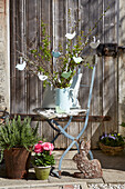 Spring branches with DIY birds made out of modelling clay in a pitcher