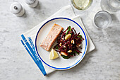 Salmon served with a beetroot and spinach salad with pears