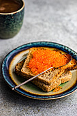 Red trout caviar on the whole wheat toast bread as a healthy food concept