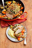 Braised turkey breast with an almond crust, served with Brussels sprouts, carrots and mashed potatoes