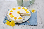 Cheese and cream cake with fondant flowers
