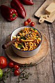 Pasta salad with red pesto, olives, and cheese