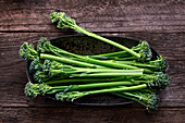 Broccolini on a wooden background