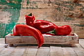 Red pointed peppers in a wooden tray