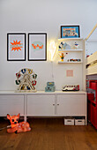 White metal cupboard with toys in children's room