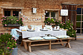 Set table on terrace, cat and DIY garland