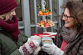 Two women toasting with mulled wine