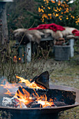Feuerschale mit brennendem Holz im Garten