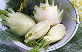 Whole and sliced fennel bulbs in a bowl