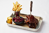 Glazed pork ribs with red cabbage salad and French fries