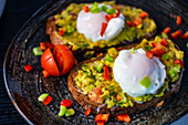 Healthy food concept with avocado toasts, vegetables and benedict eggs
