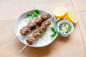 Meatball skewers with yogurt soup and mint butter