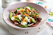 Egg salad with avocado and bacon, pumpkin seeds and blue cheese