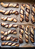 Vegan puff pastry nut twists on a baking tray