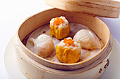 Dim Sum with red caviar in a bamboo steamer