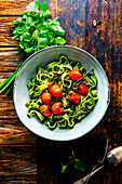 Pasta with parsley-pumpkin seed pesto and cherry tomatoes
