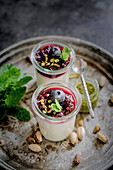 Coconut semolina pudding with berries and pistachios