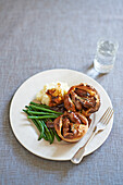 Hearty muffins with sausages, served with mashed potatoes and green beans