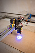 Laser wood printer creating a print