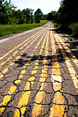 Yellow lines on a cracked road