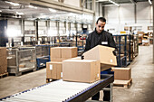 Distribution centre worker sorting packages
