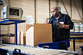 Worker using a barcode reader in a warehouse