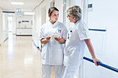 Nurses conferring in the corridor of a hospital