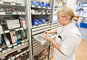 Nurse picking medication in a medicine room