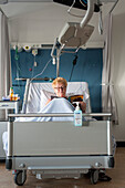 Patient in a hospital reading a magazine