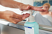 Nurse disinfecting her hands