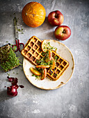 Hearty pumpkin waffles with apples and cress