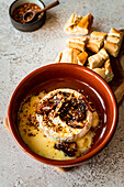Oven baked Brie with fried dates and honey, sprinkled with Dukkah and Aleppo Pepper