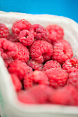 Fresh raspberries in a paper crate (close-up)