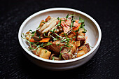 Pork belly with pickled vegetables in a bowl