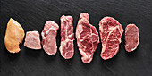 Various cuts of raw meat (turkey, chicken, pork, beef, lamb)