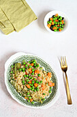 Couscous with artichoke hearts, peas and carrots