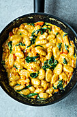 Gnocchi with pumpkin, spinach, and cream cheese sauce