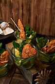 Fried chicken with cucumber salad served in glasses