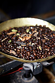 Coffee beans in bowl of vintage kitchen scale