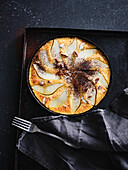 Pancake with pear slices, almonds and icing sugar