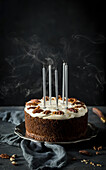 A carrot cake with blown-out candles