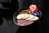 Breakfast bowl with fresh fruit and frozen berries yogurt
